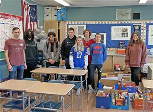 Students posing with donated food